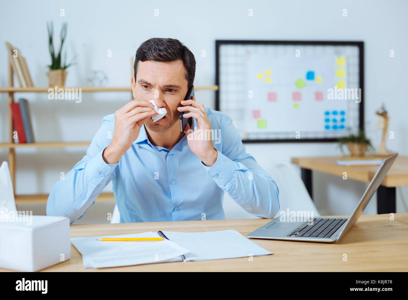 Attentive office worker having telephone call Stock Photo