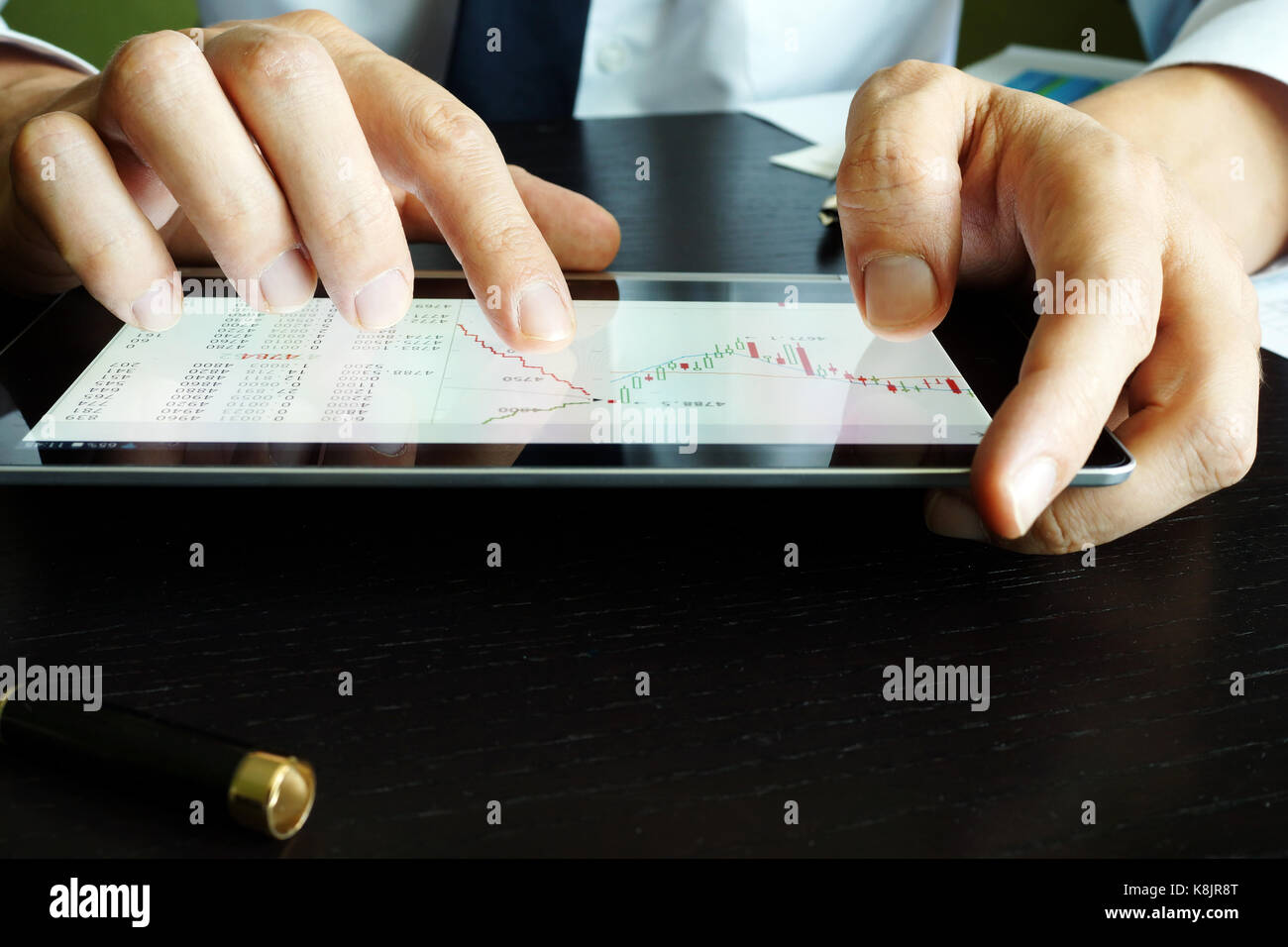 Trader holding tablet with stock market graph. Trading. Stock Photo