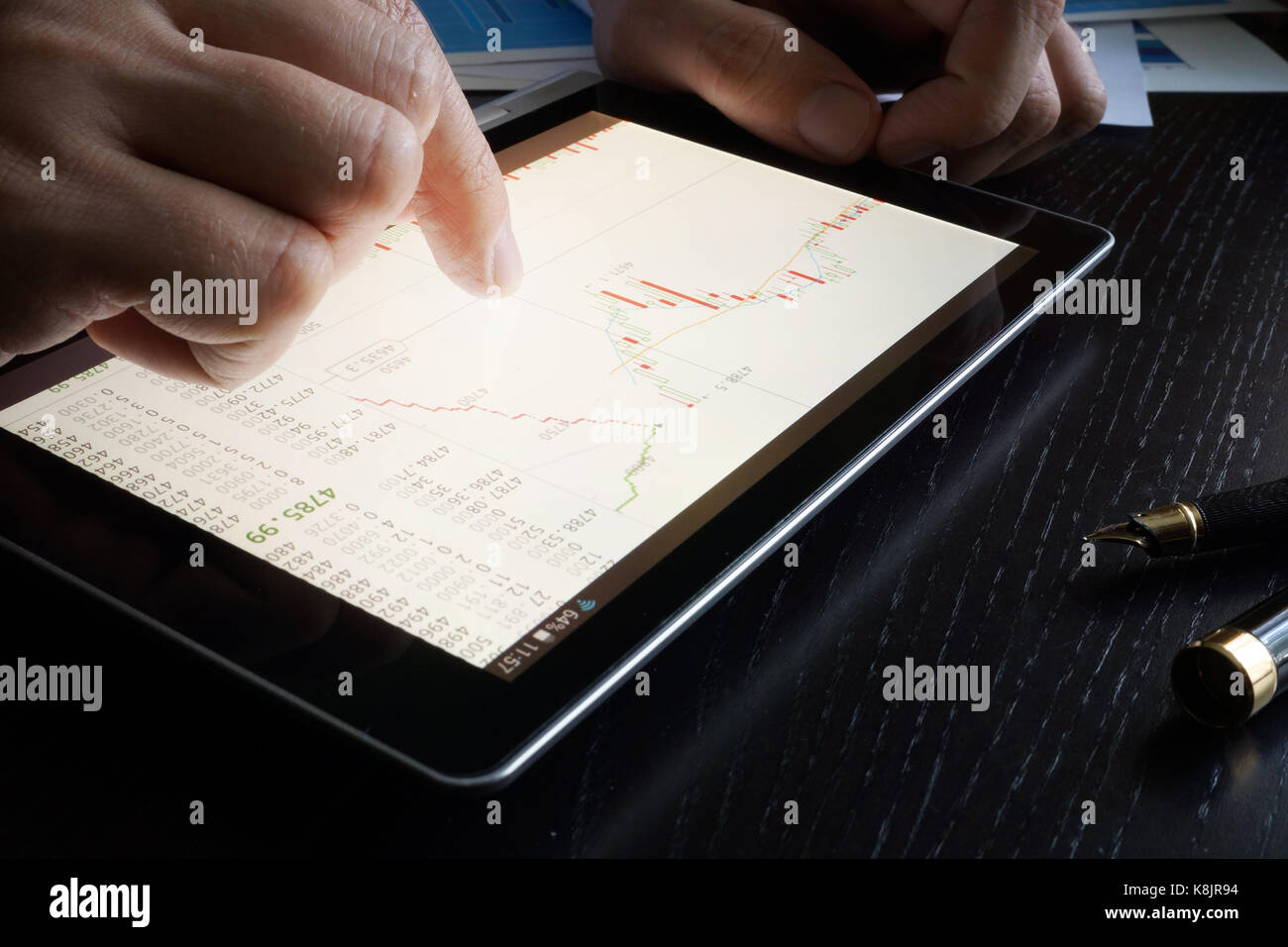 Stock trading data on a tablet screen. Stock Photo