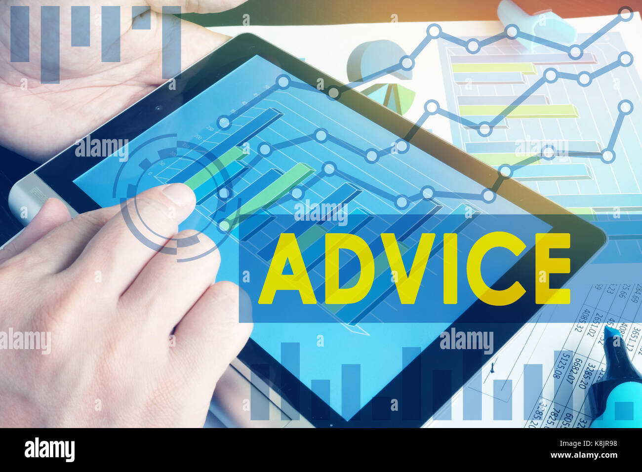 Expert advice for business and trading. Tablet and financial graphs. Stock Photo