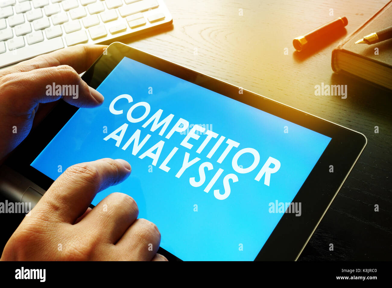 Business man is reading about competitor analysis. Stock Photo