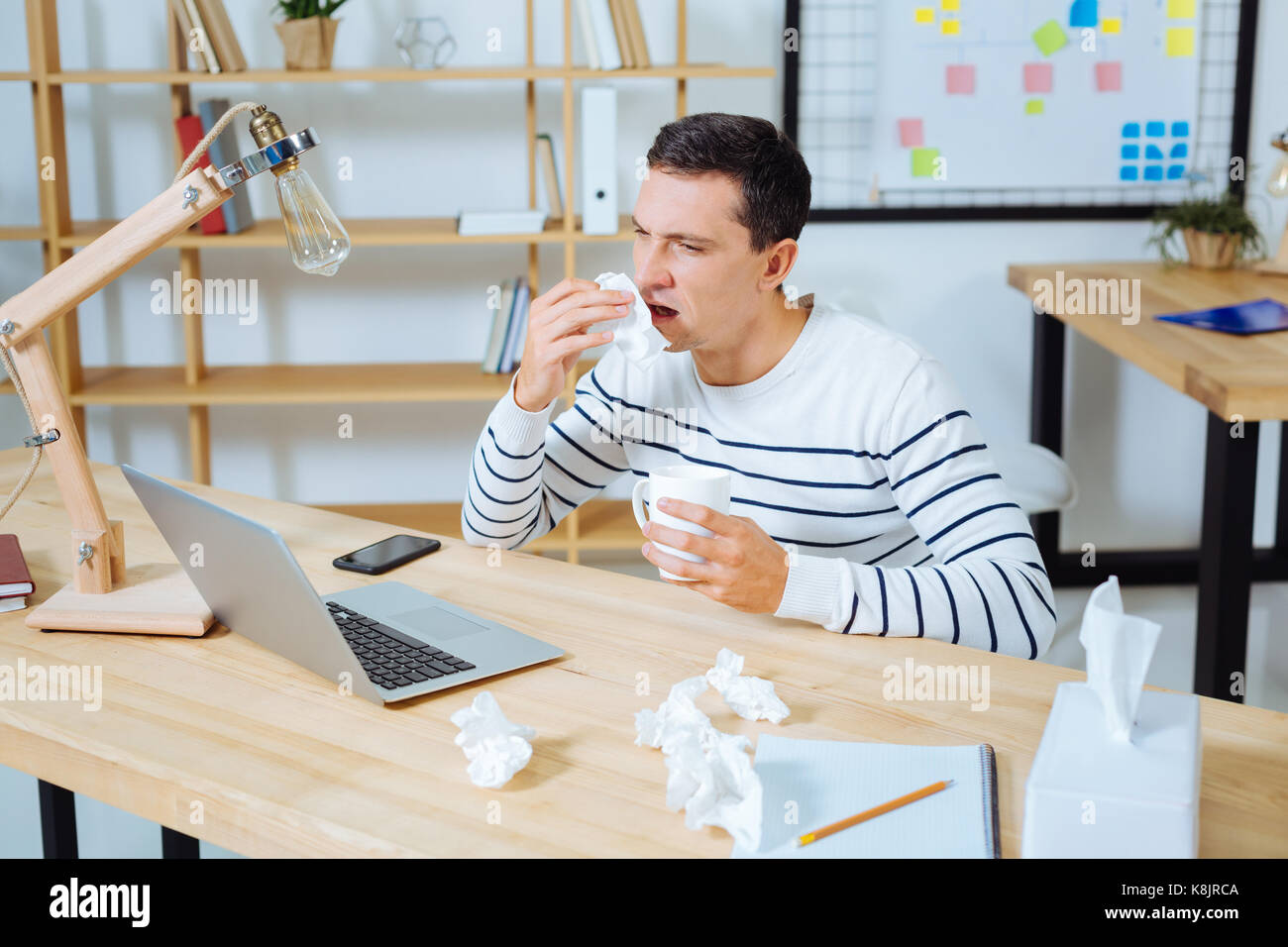 Sick brunette male going to sneeze Stock Photo