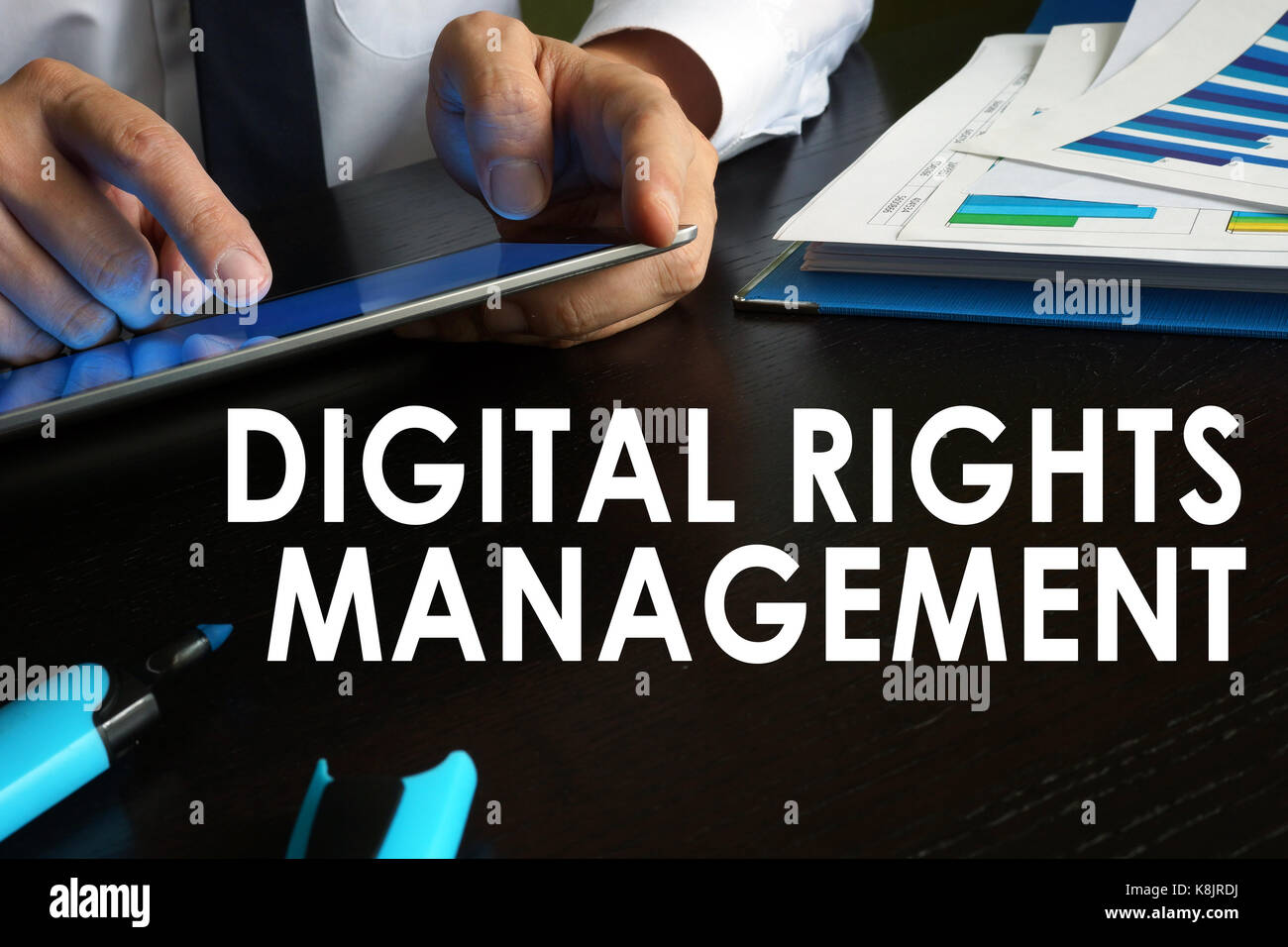 Digital rights management concept. Man is using tablet. Stock Photo