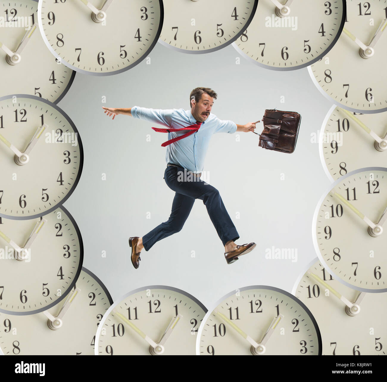 Businessman running over alarm clock Stock Photo Alamy