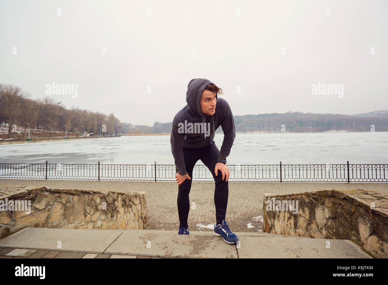 Young gay man in sportswear in a park for a jog. Stock Photo