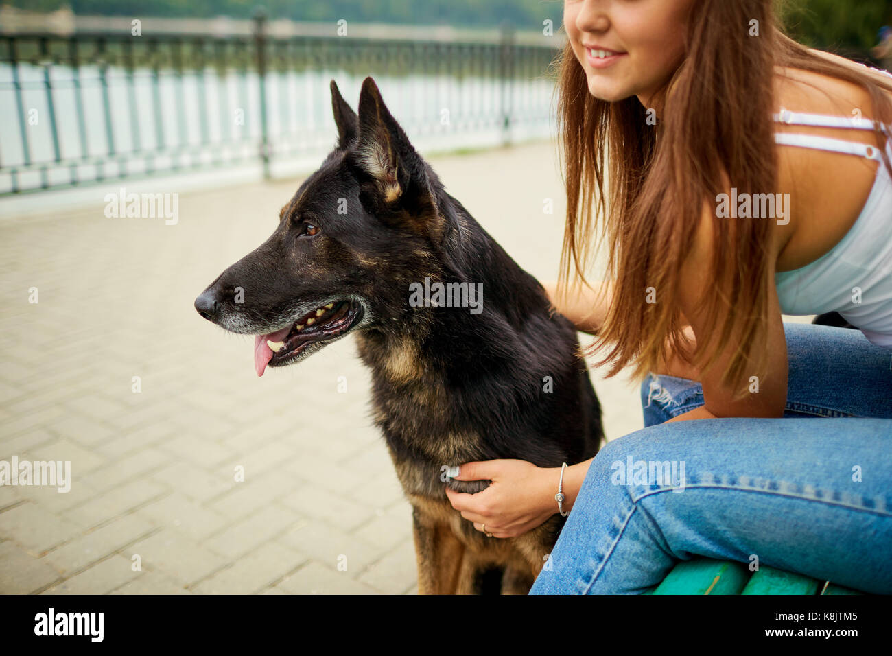 Portrait of a young girl with a dog in the park Stock Photo - Alamy