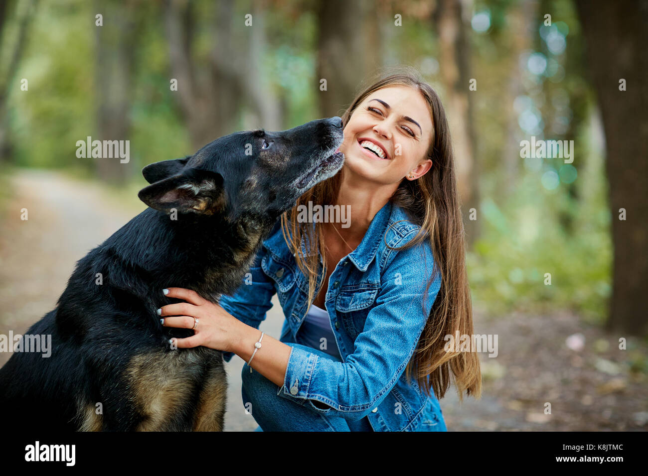 Portrait of a young girl with a dog in the park Stock Photo - Alamy