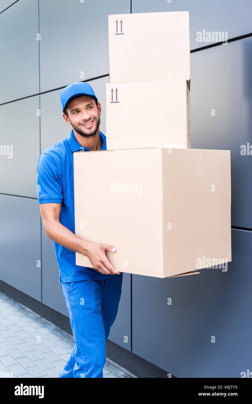 delivery man with stack of boxes Stock Photo - Alamy
