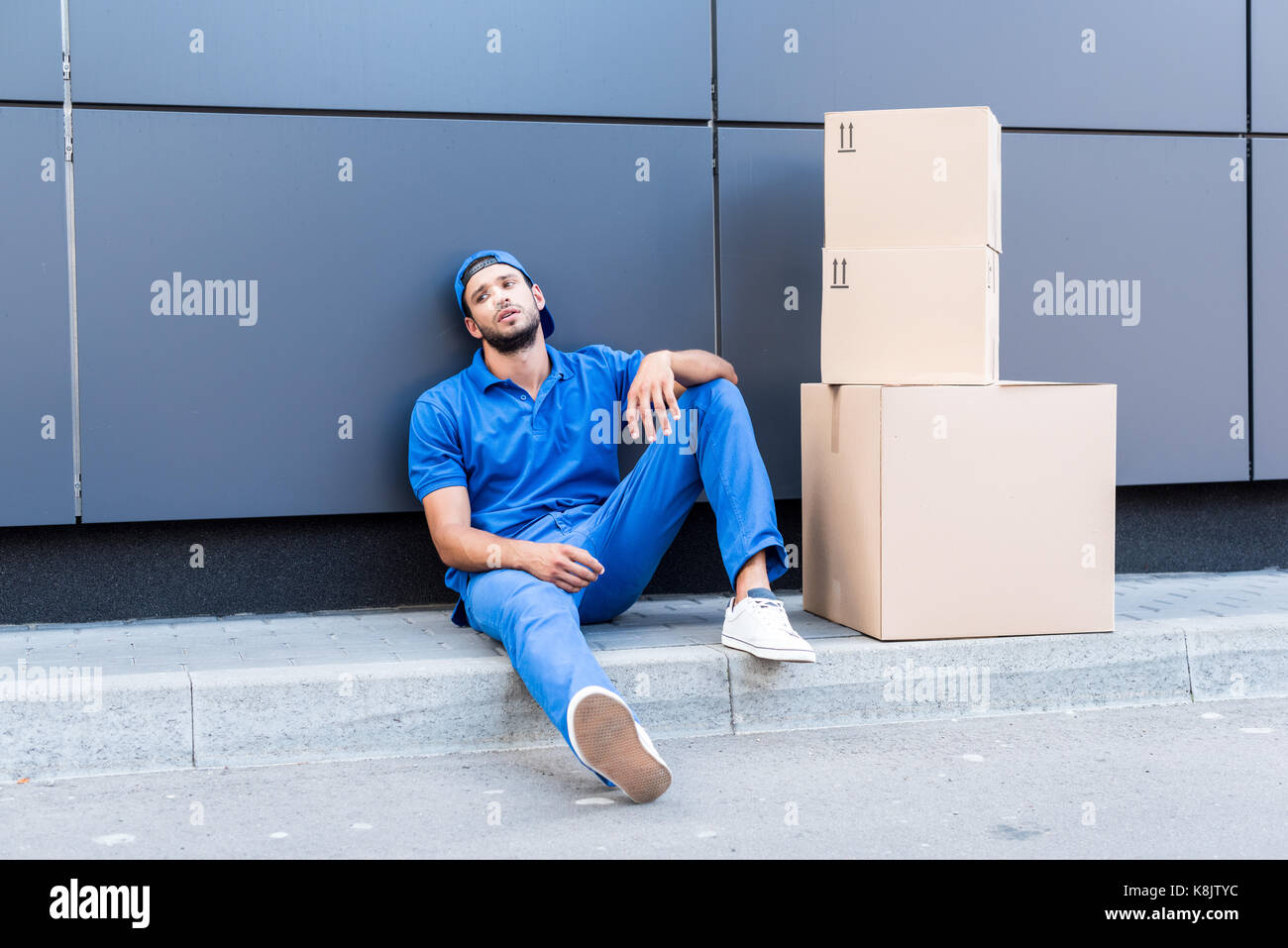 exhausted delivery man Stock Photo