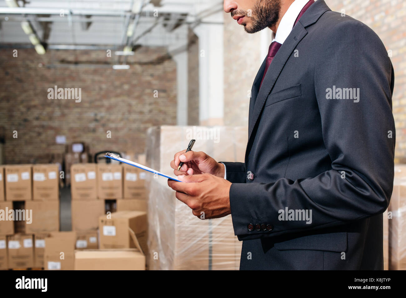 businessman writing on clipboard Stock Photo - Alamy