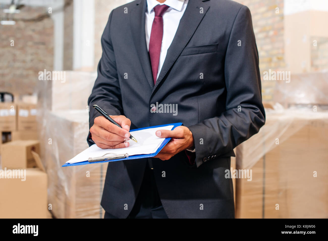 businessman writing on clipboard Stock Photo - Alamy
