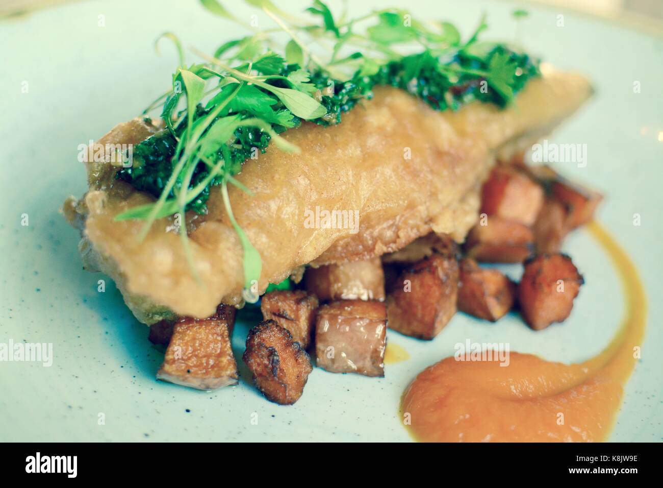 Gourmet battered fish with fried sweet potatoes - filter applied Stock Photo