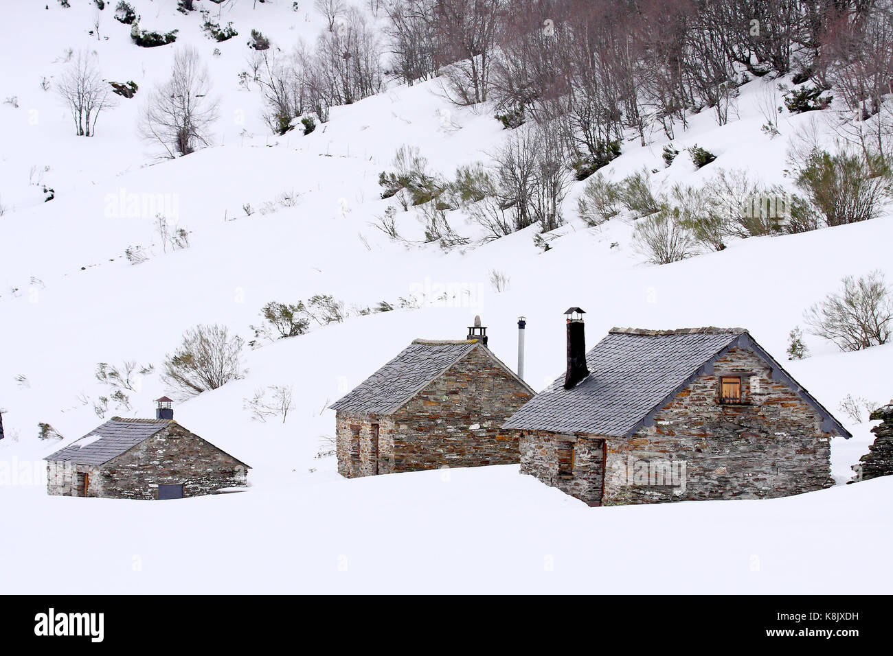 Group of cabins in the snow in winter in brana de Buenverde, Laciana's valley, Leon, Spain. Stock Photo