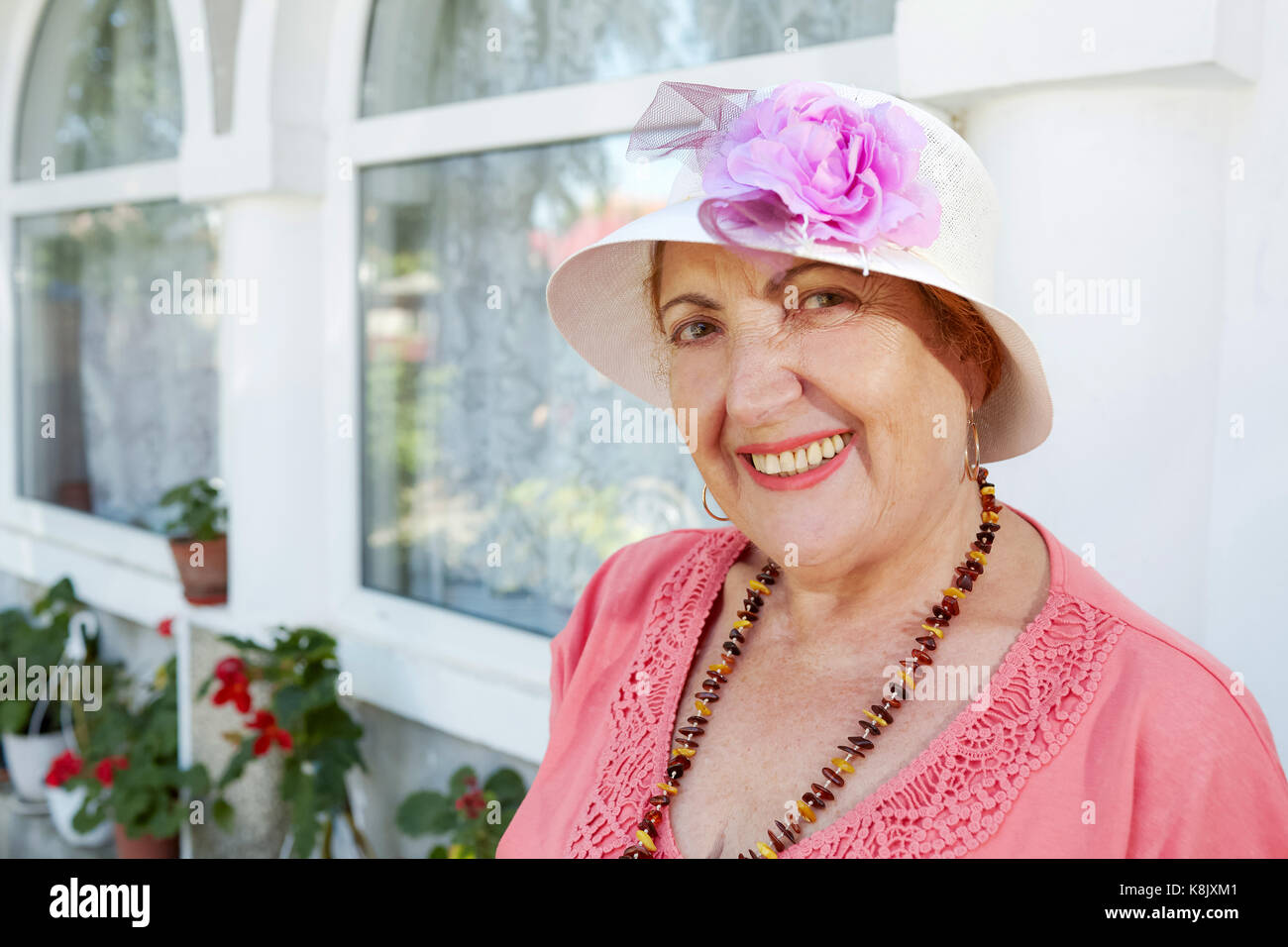 Elderly woman wearing pink hi-res stock photography and images - Alamy