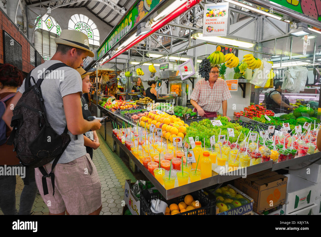 Valencia Spain food, view of people shopping at a fruit juice stall inside the Mercado Central