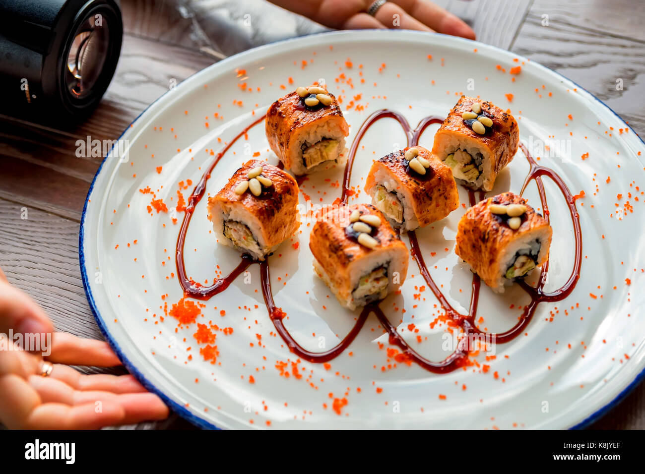 Food photographer takes picure of sushi rolls Stock Photo