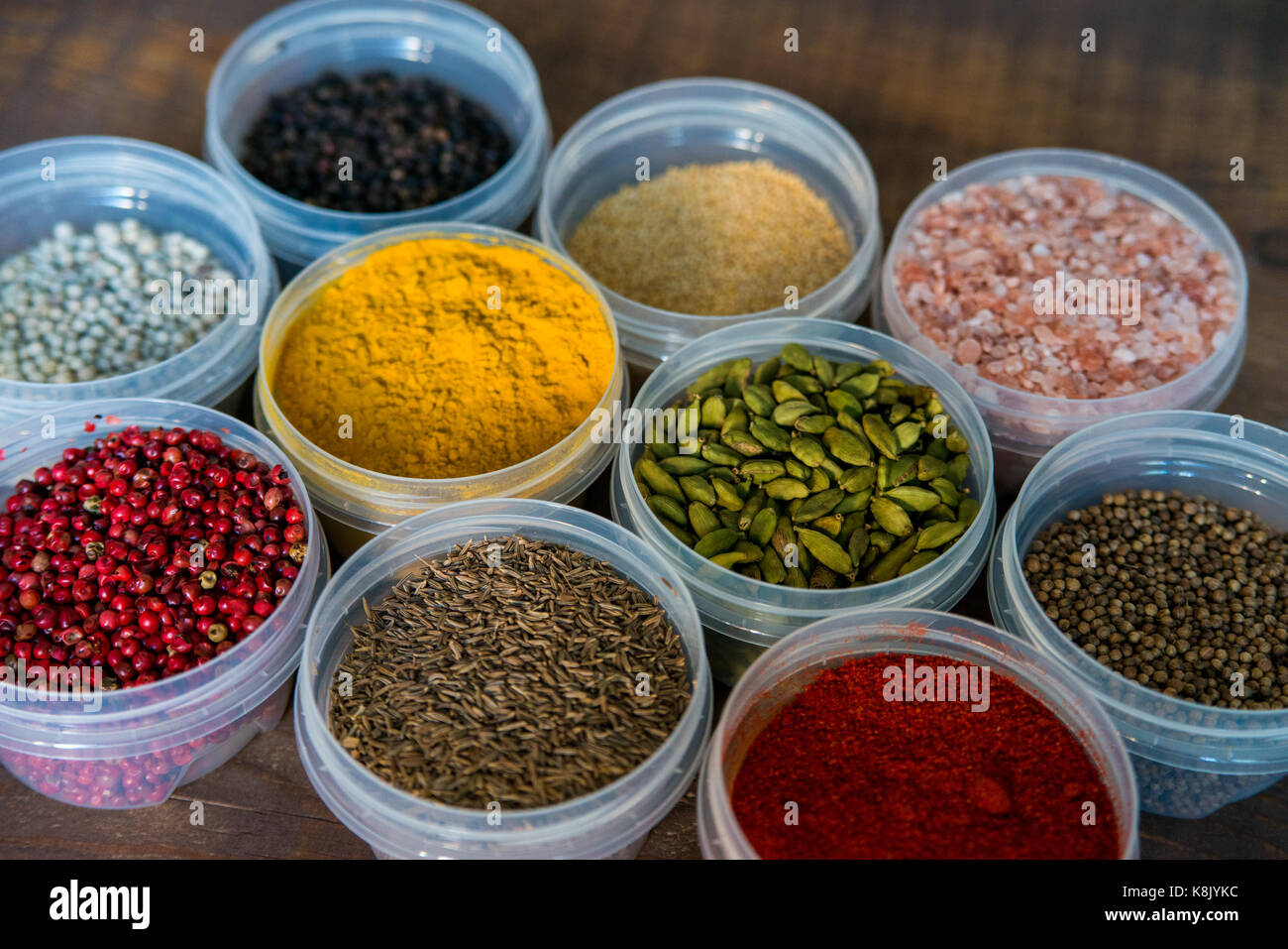 Various colorful spices in plastic containers Stock Photo Alamy