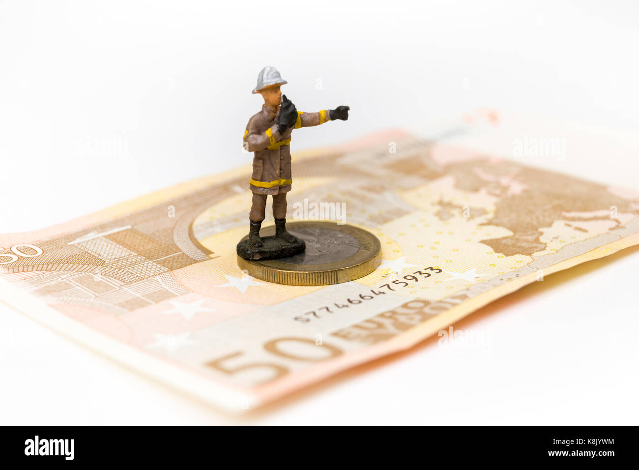 Miniature Fireman On Euro Coin And Banknote On White Background Salary Savings European Union 