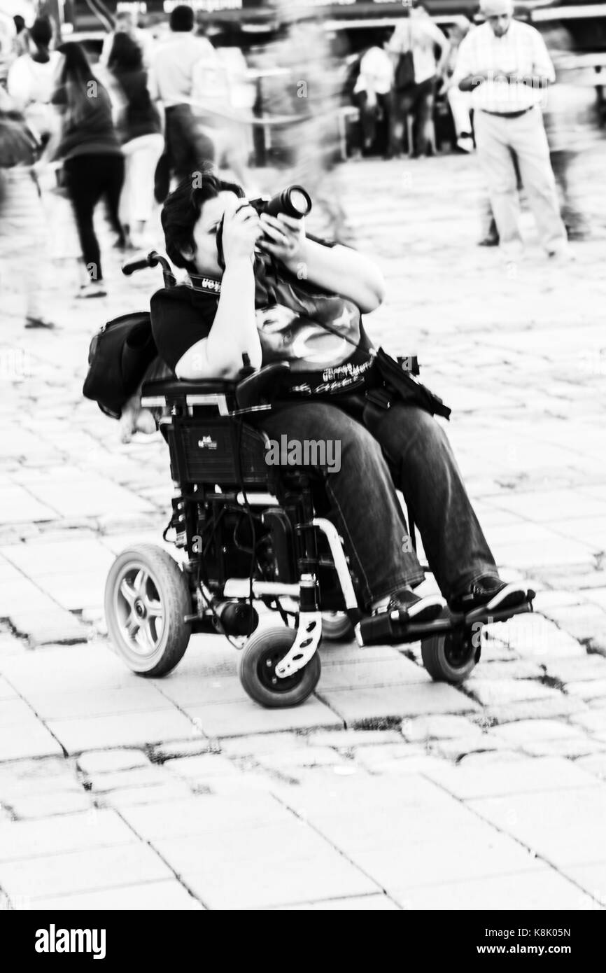 Handicapped woman shooting with dslr camera Stock Photo