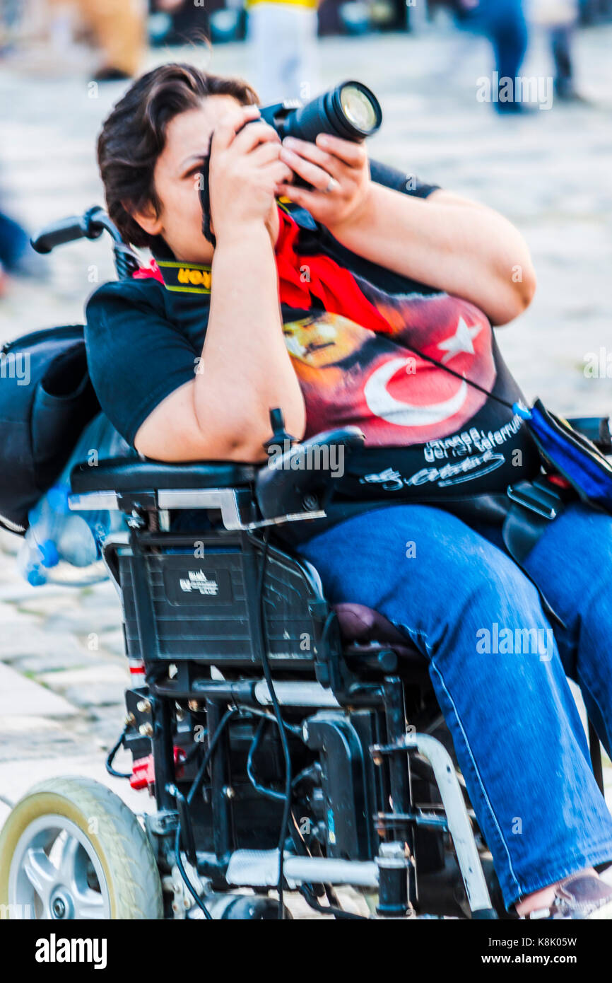 Handicapped woman shooting with dslr camera Stock Photo