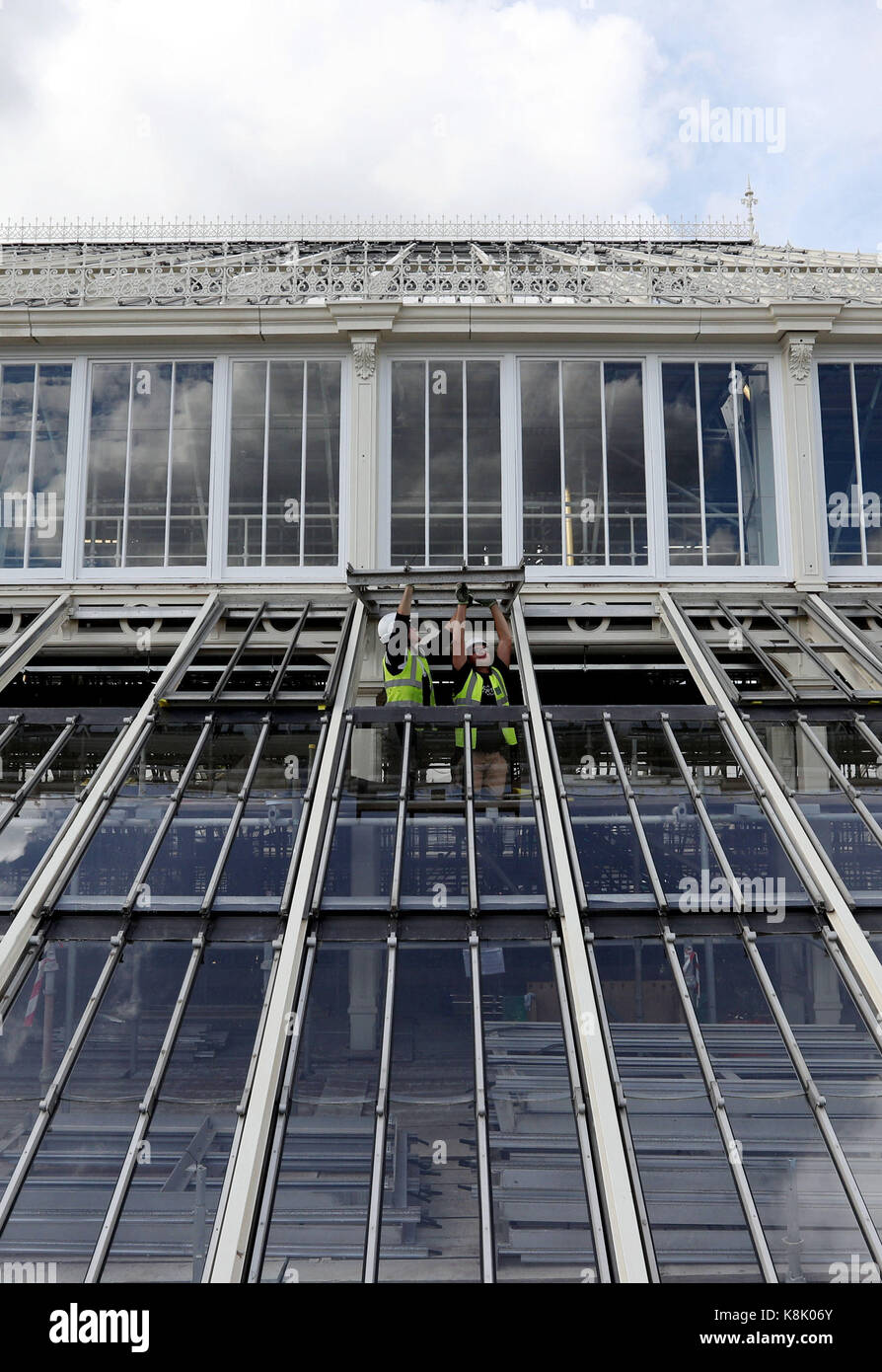 Workmen in the Royal Botanic Gardens in Kew, SW London, adjust the windows on the Temperate House that will re-open in May next year after the &Acirc;£41 million five year restoration project of the world's largest Victorian Glasshouse, which was designed by Decimus Burton and opened in 1863. Stock Photo