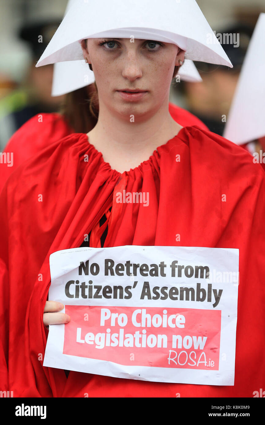 Members of ROSA - (Reproductive rights, against Oppression, Sexism & Austerity) dressed as Handmaids outside Leinster House, as the first public meeting of the Dail Committee on the 8th Amendment took place to consider the recommendations of the Citizens Assembly. Stock Photo