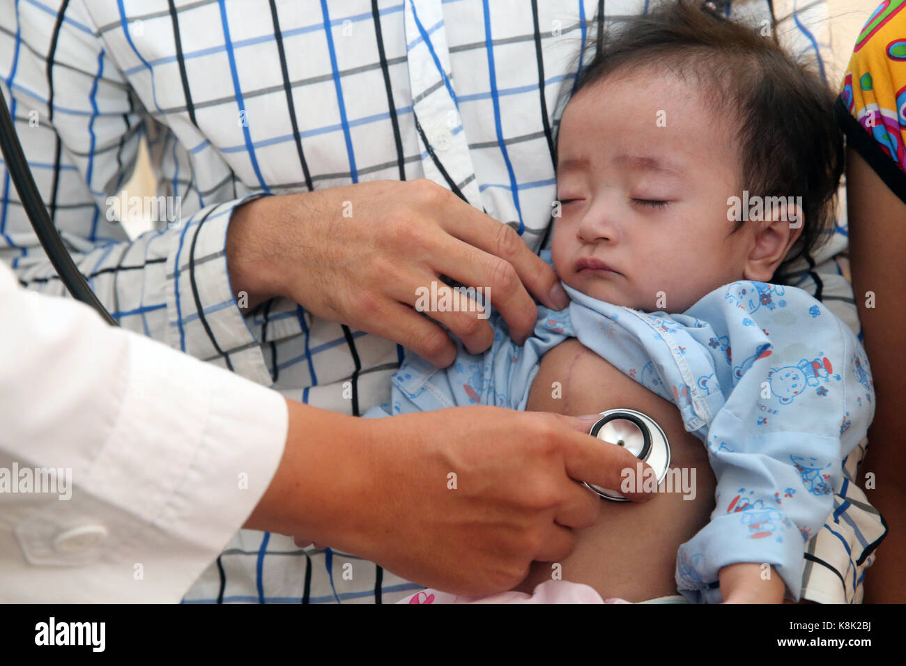 Tam duc heart hospital. doctor listening to young girl's heart. ho chi minh city. vietnam. Stock Photo