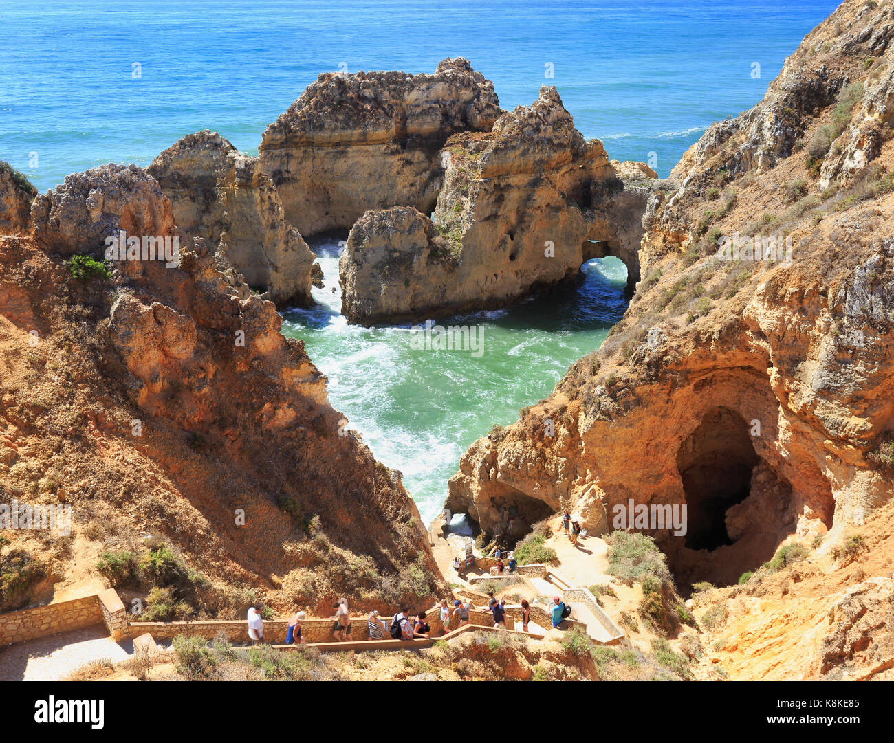 LAGOS, PORTUGAL - JULY 04, 2017: Tourists enjoying the view of Atlantic Ocean shoreline in Ponta da Piedale Point, Algarve, Portugal Stock Photo