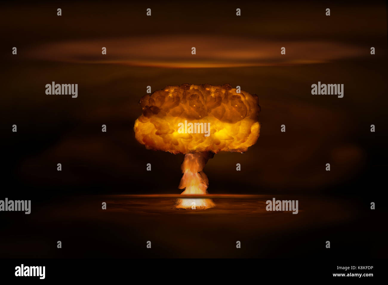 Atomic bomb realistic explosion, orange color with smoke on black background Stock Photo