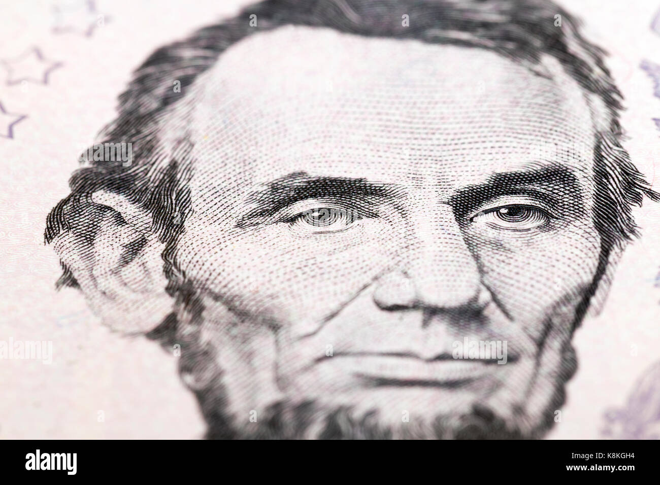 American President Lincoln on a bill of five dollars of the 2006 model. Photo close-up at an angle, in the focus of the president eyes Stock Photo