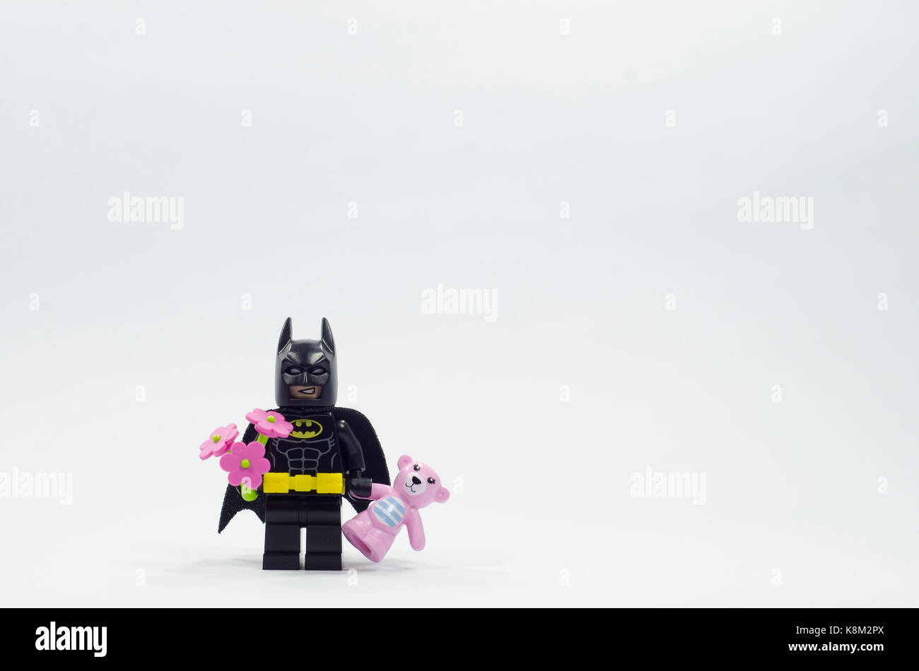 lego batman minifigure holding flower and pink teddy bear Stock Photo -  Alamy