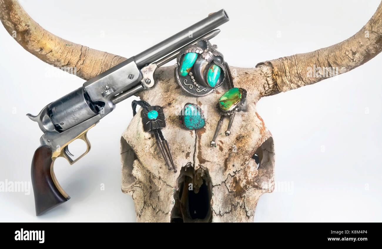Antique cowboy pistols and cow skull with Navajo Jewelry. Stock Photo