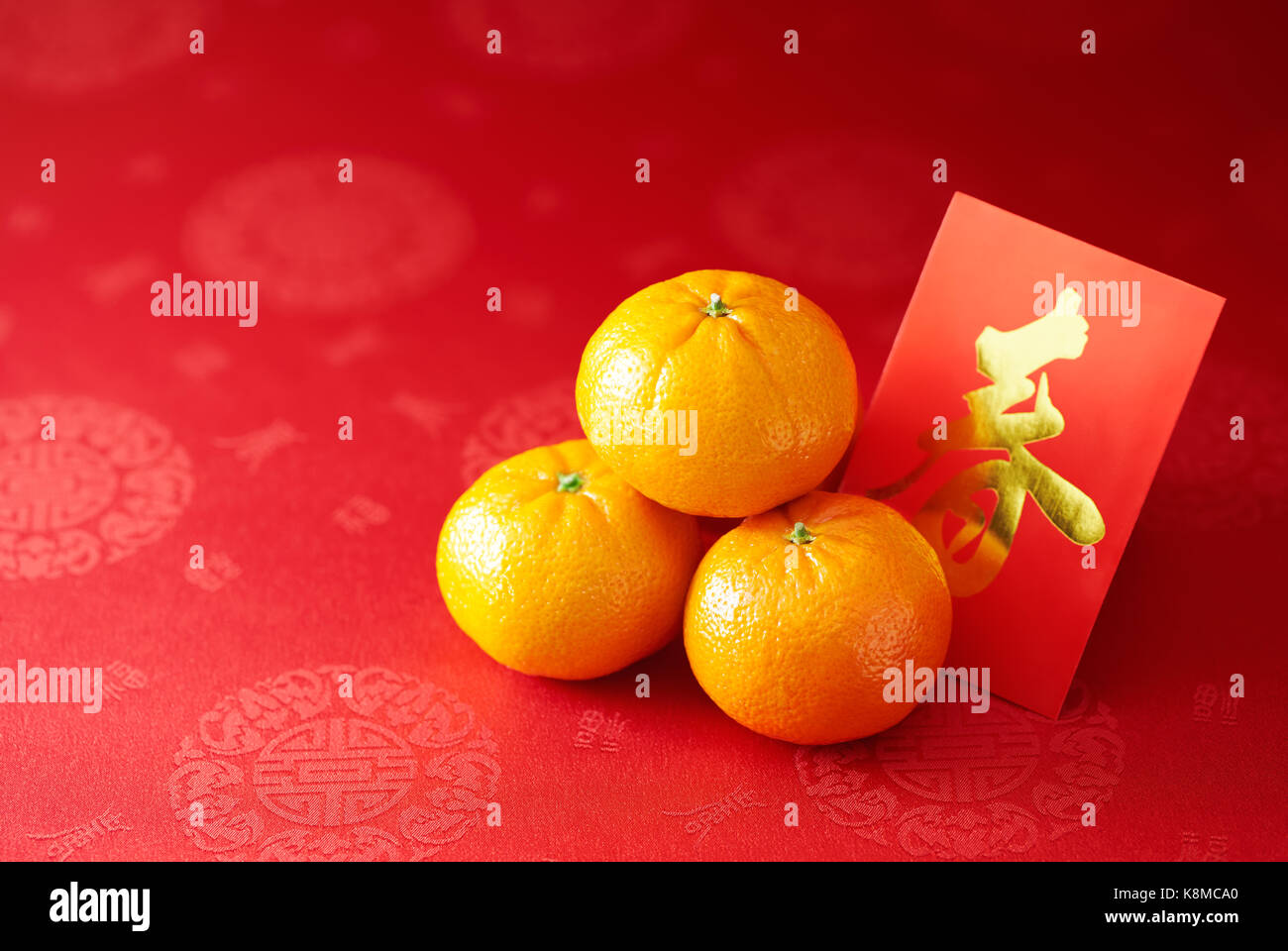Chinese New Year - Mandarin orange and red packet (Foreign text means spring season) Stock Photo