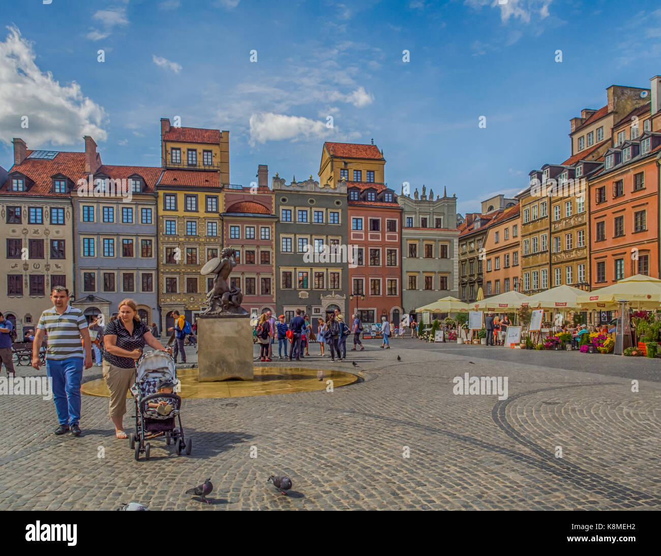 Warsaw, Poland - June 02, 2017: Cafes, stalls, colorful buildings  and the people at Old Town Square (Rynek Stare Miasto) during the summer time, UNES Stock Photo