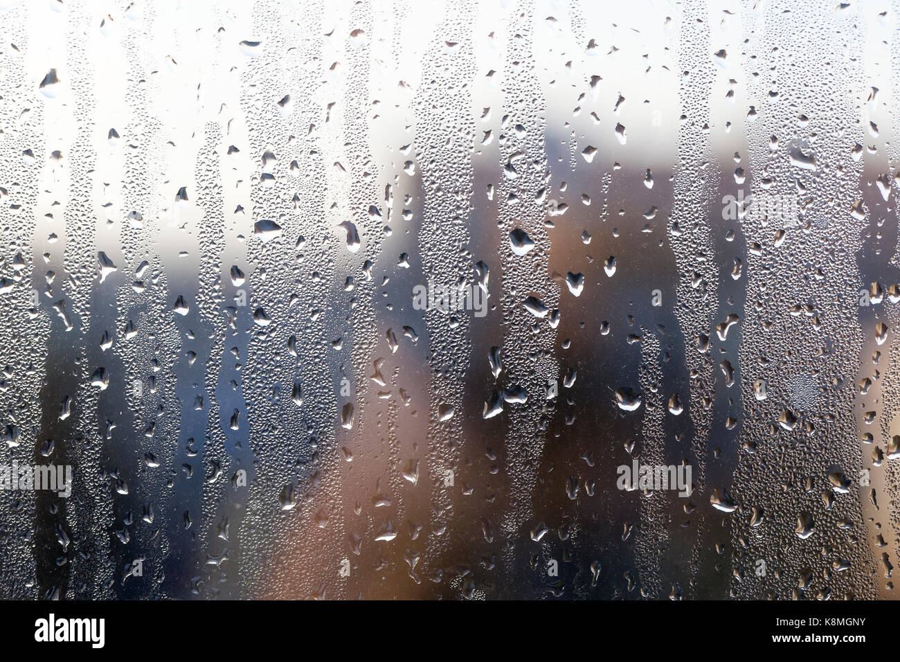 photographed close-up of water droplets on the glass window after the ...