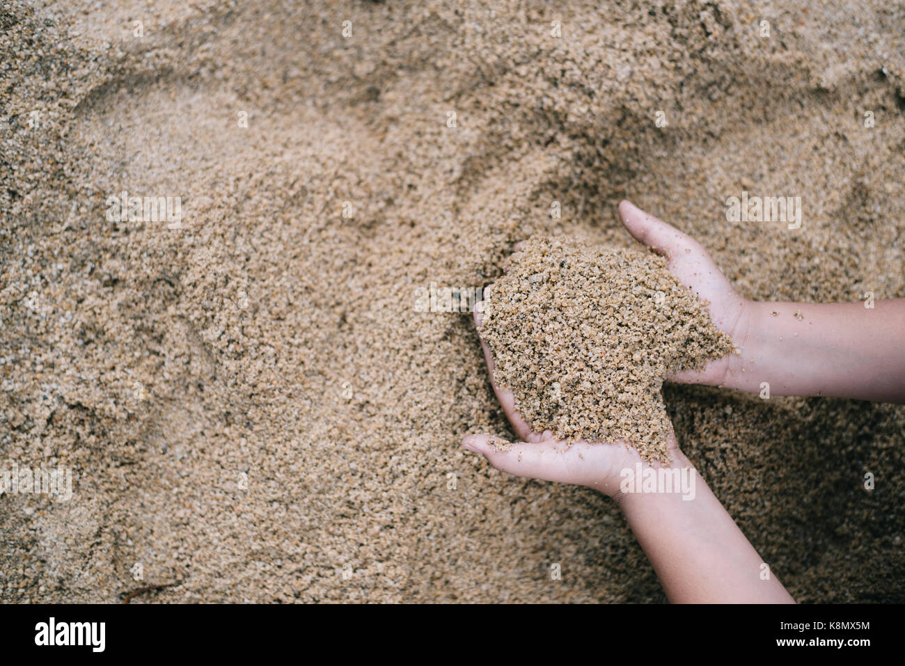 kid playing sand with hand (selective focus).kids growth developmant,kids activity,kids hygiene concept Stock Photo