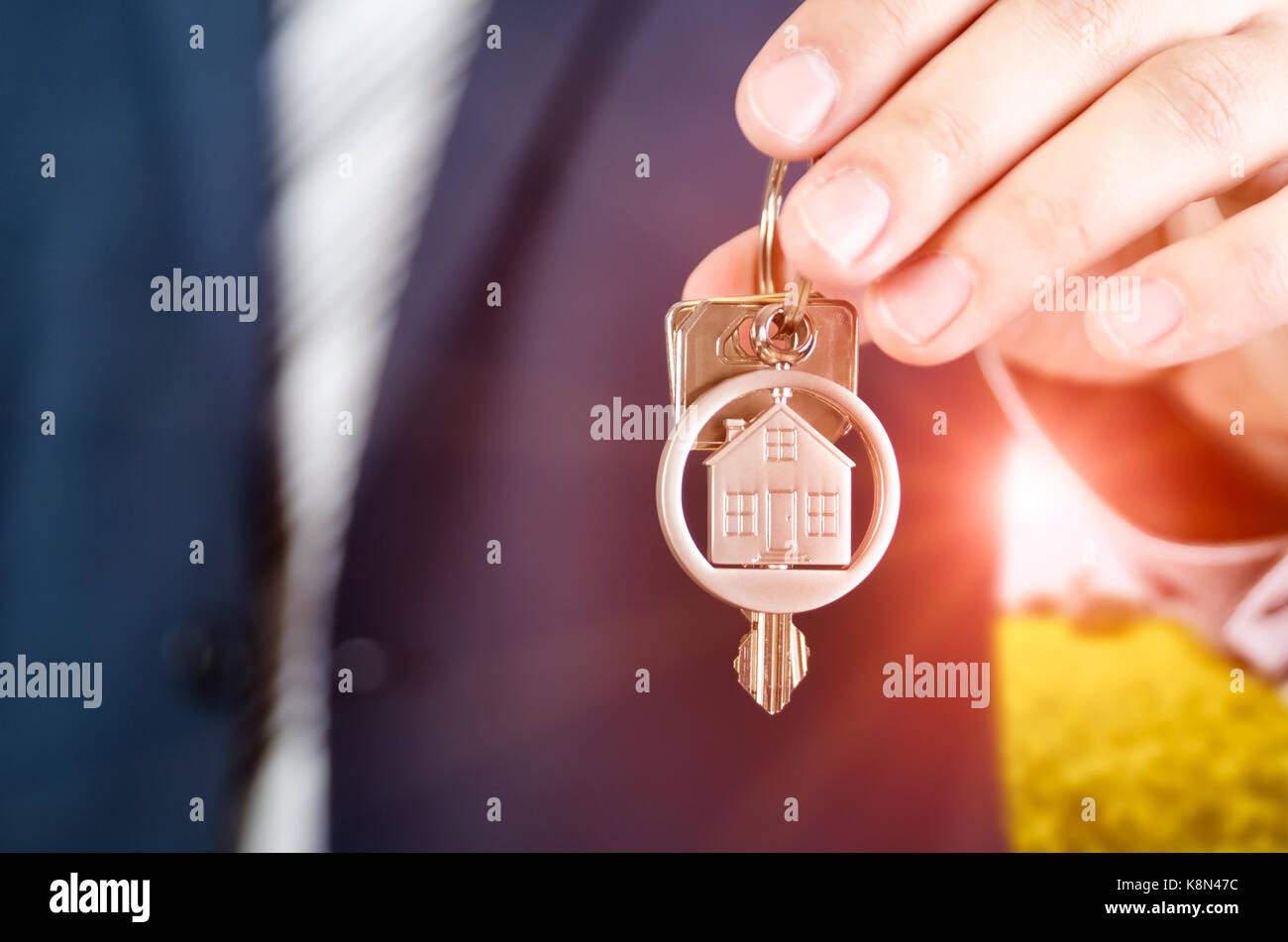 Real estate agent holding key of new apartment close up. realestate key