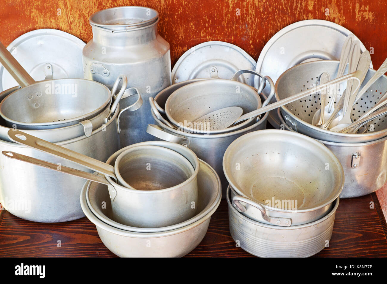 Old aluminum kitchen utensils are saucepans, colanders, pan, pot