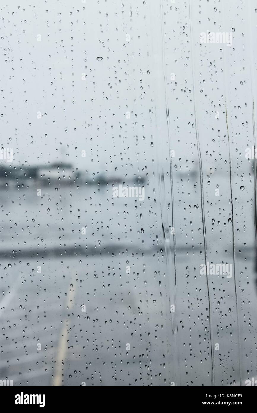 Rain on the window view of LaGuardia Tarmac on a rainy day from inside the airport terminal. Stock Photo