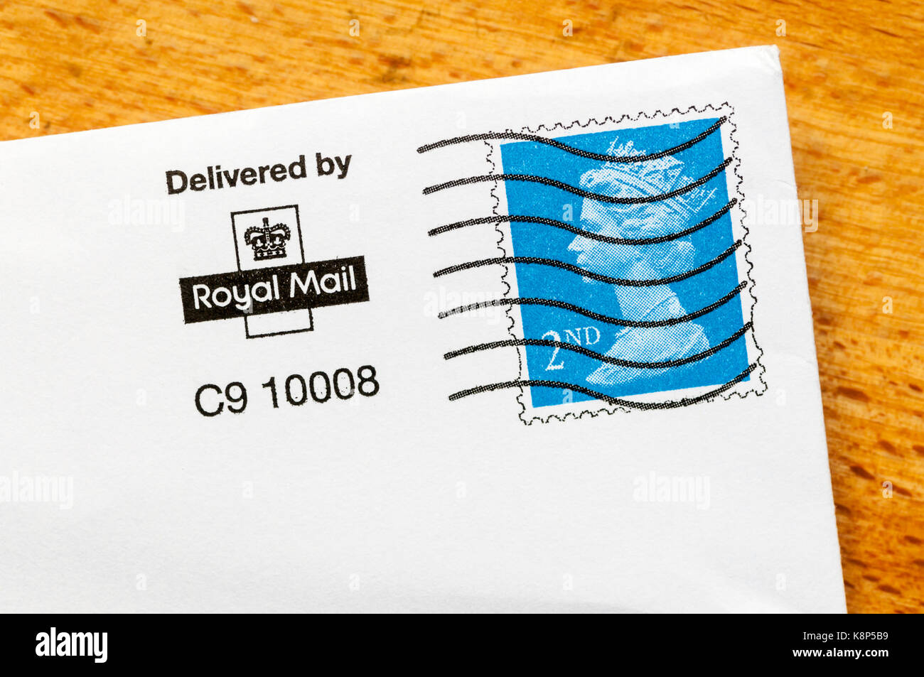 A pre-printed UK 2nd class postage stamp on an envelope. Stock Photo