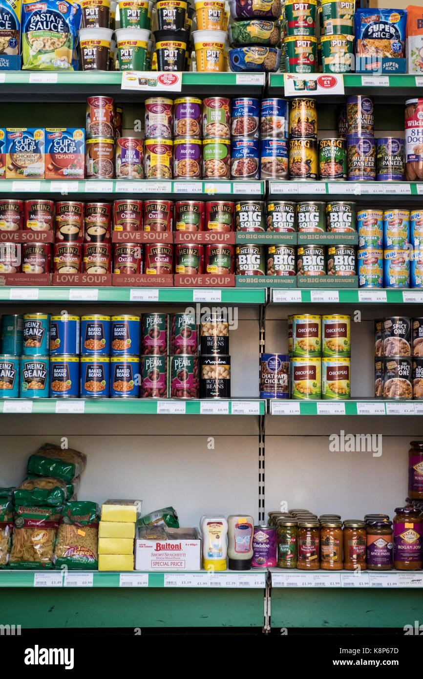 Grocery store shelves. Bagged, boxed, bottled and canned or tinned food products on the shelves of a small local shop, Nottingham, England, UK Stock Photo