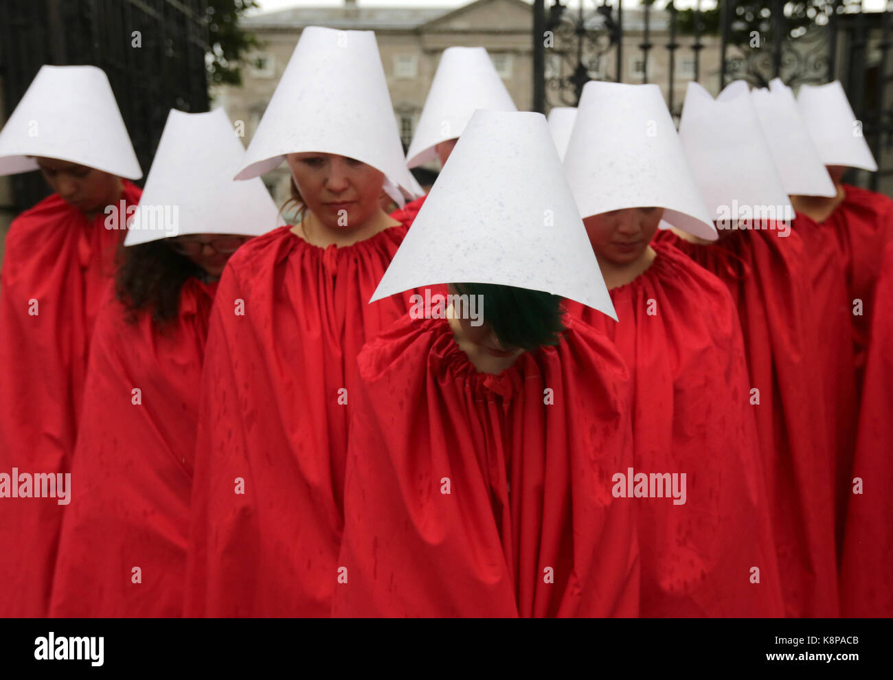 Dublin, Ireland. 20th September 2017.  A group of ‘Handmaids’ are pictured outside the gates of the Irish Parliament, Leinster House, in Dublin, today as the Oireachtas Committee on the 8th Amendment starts its public sessions. The protesters are calling for full bodily autonomy for pregnant women. The protest was organised by ROSA (Reproductive rights, against Oppression, Sexism and Austerity).  Credit : Laura Hutton/Alamy Live News. Stock Photo