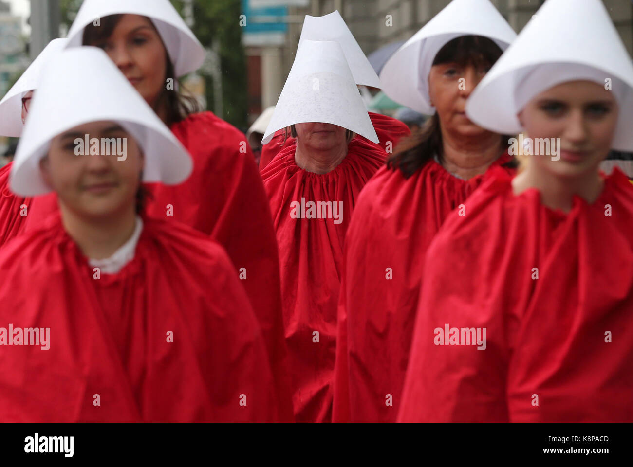 Dublin, Ireland. 20th September 2017.  A group of ‘Handmaids’ are pictured outside the gates of the Irish Parliament, Leinster House, in Dublin, today as the Oireachtas Committee on the 8th Amendment starts its public sessions. The protesters are calling for full bodily autonomy for pregnant women. The protest was organised by ROSA (Reproductive rights, against Oppression, Sexism and Austerity).  Credit : Laura Hutton/Alamy Live News. Stock Photo