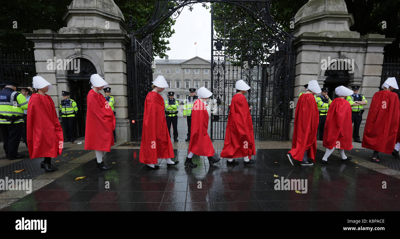 Dublin, Ireland. 20th September 2017. A group of ‘Handmaids’ are pictured outside the gates of the Irish Parliament, Leinster House, in Dublin, today as the Oireachtas Committee on the 8th Amendment starts its public sessions. The protesters are calling for full bodily autonomy for pregnant women. The protest was organised by ROSA (Reproductive rights, against Oppression, Sexism and Austerity).  Credit : Laura Hutton/Alamy Live News. Stock Photo
