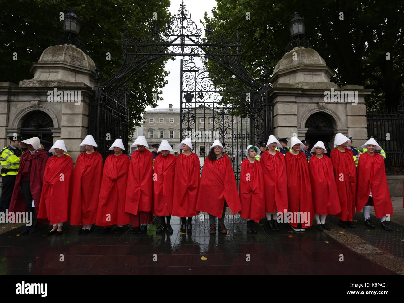 Dublin, Ireland. 20th September 2017.  A group of ‘Handmaids’ are pictured outside the gates of the Irish Parliament, Leinster House, in Dublin, today as the Oireachtas Committee on the 8th Amendment starts its public sessions. The protesters are calling for full bodily autonomy for pregnant women. The protest was organised by ROSA (Reproductive rights, against Oppression, Sexism and Austerity).  Credit : Laura Hutton/Alamy Live News. Stock Photo