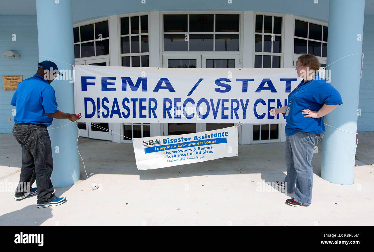 West Palm Beach, Florida, USA. 20th Sep, 2017. Martins Nnoko and Andi Wilson, with the SBA Disaster Assistance sets up their sign at the FEMA/State Disaster Recovery Center that has opened at the Carolyn Sims Center, 225 NW 12th. Avenue in Boynton Beach, Florida on September 20, 2017. The Disaster Recovery Center will help Florida storm survivors. The DRC will be open 9 a.m. to 6 p.m. Monday through Sunday until further notice. To speed recovery, survivors are urged to register before visiting a DRC. To register, go online to www.DisasterAssistance.gov or call the FEMA Helpline at 800 Stock Photo