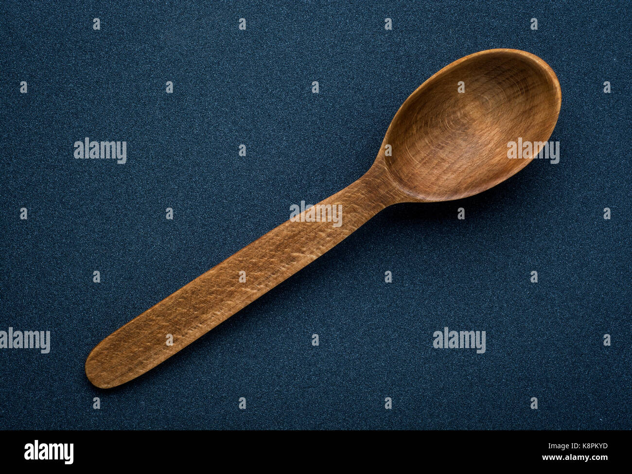 Wooden spoon on dark wooden background Stock Photo