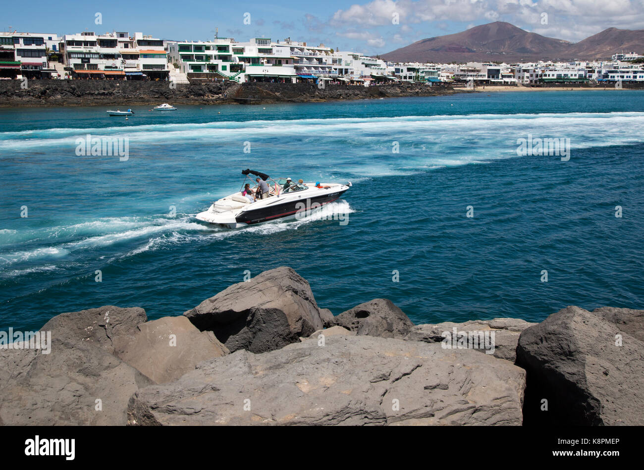 Motor boat leaving harbour at Playa Blanca, Lanzarote, Canary Islands, Spain Stock Photo