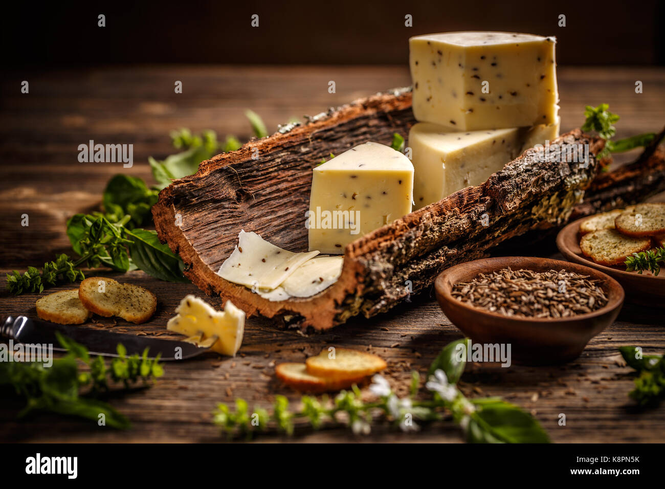 Cheese on a bark with caraway seeds Stock Photo Alamy