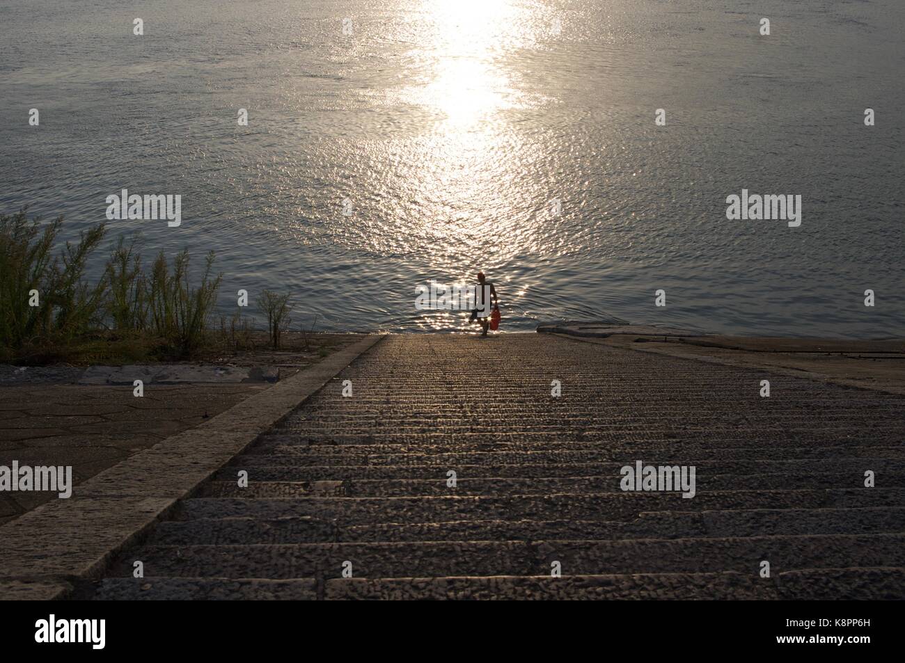 Yichang residents swim in the Yangtze river, downstream from the Three Gorges Dam, on a summer evening. August 2015. Stock Photo